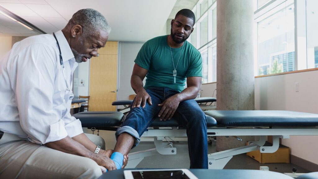 Orthopedic doctor examining joint pain in a patient in their 40s during early diagnosis consultation